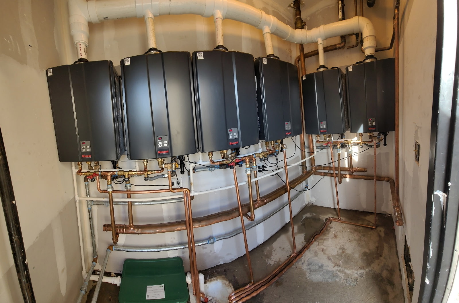 Commercial multi-unit Rinnai tankless water heater system installed by Western Sky Plumbing in Phoenix