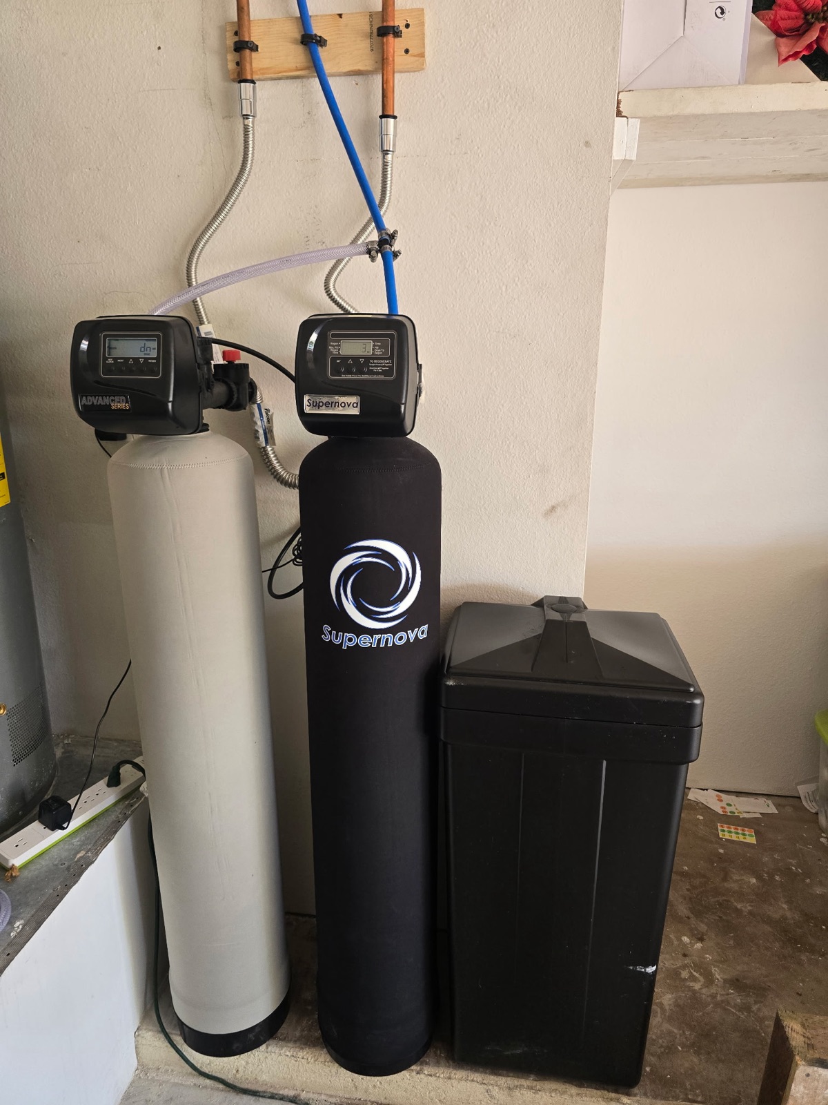Whole-home water softener, filter tank and brine tank installed in a Phoenix garage